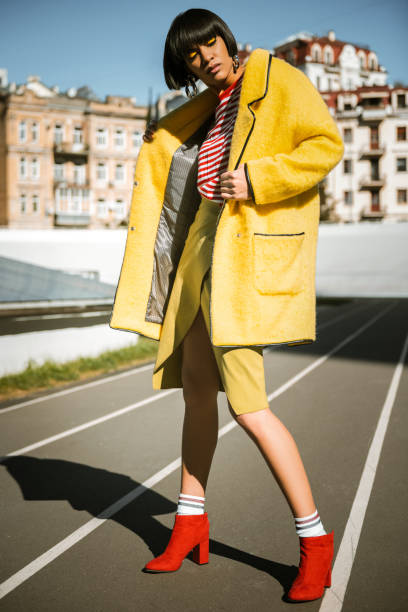 istock Short-haired slim female uncovering her oversized cape 1063011586
