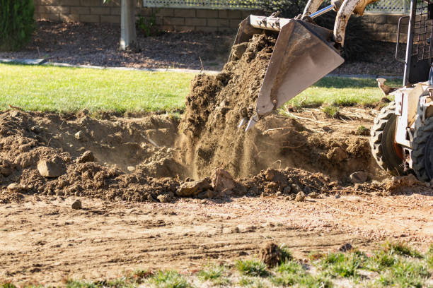 istock Small Bulldozer Digging In Yard For Pool Installation 1063017858
