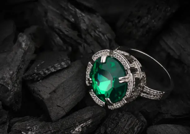 jewelry ring with big gem on dark coal background