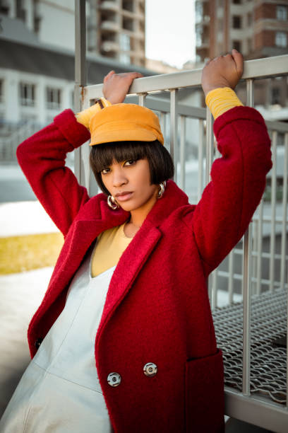 fashionable colorful lady posing in woolen red coat - earring multi colored shoe jewelry imagens e fotografias de stock