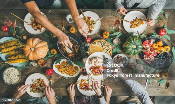 Flatlay Of Friends Feasting At Thanksgiving Day Table With Turkey Stock Photo - Download Image Now