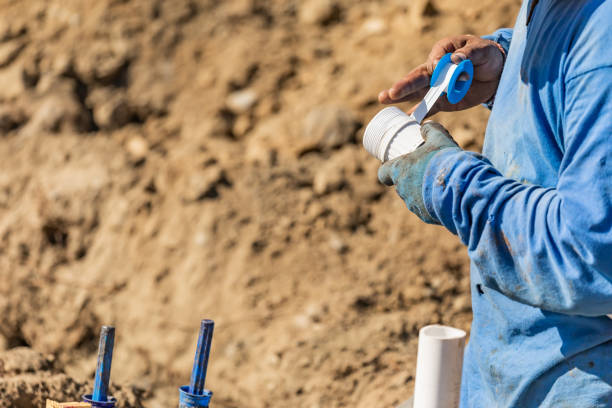 istock Plumber Applying PTFE Tape To PVC Pipe At Construction Site 1063028110