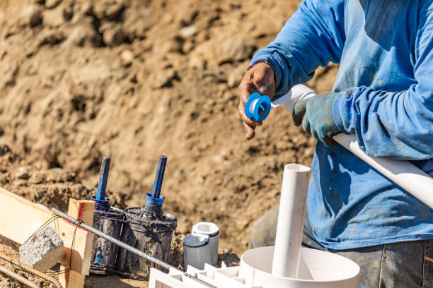 istock Plumber Applying PTFE Tape To PVC Pipe At Construction Site 1063028154