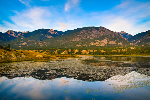 Mountains reflected in the Columbia Wetlands in Fall or Autumn, near Invermere, British Columbia, Canada