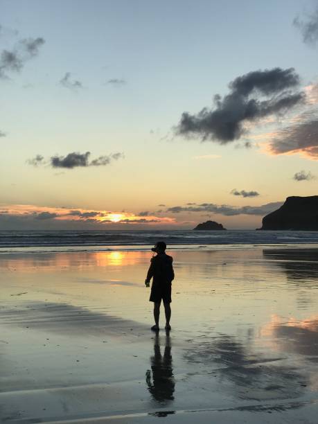 istock Sunset with person and reflection on a beach 1063032266
