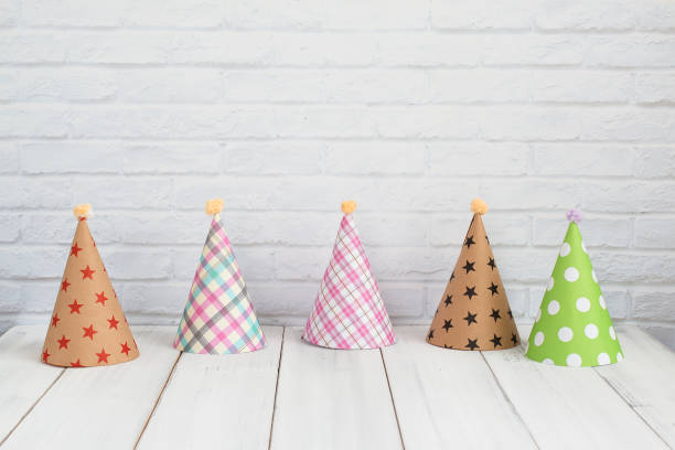 istock party hat on white wood table over white background with copy space 1063032404