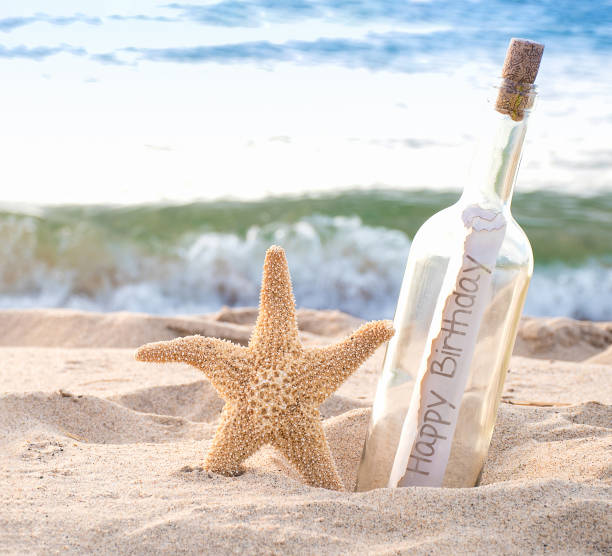 starfish with birthday message in bottle stock photo