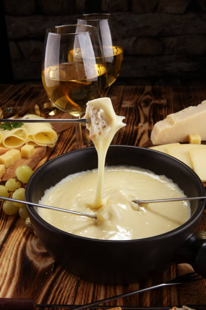 istock Gourmet Swiss fondue dinner on a winter evening with assorted cheese 1063040054