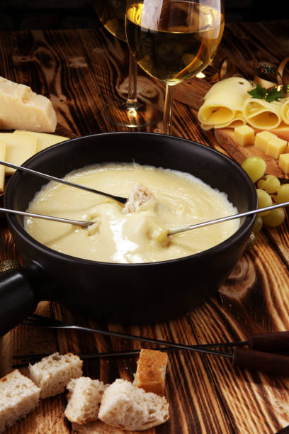 istock Gourmet Swiss fondue dinner on a winter evening with assorted cheese 1063041754