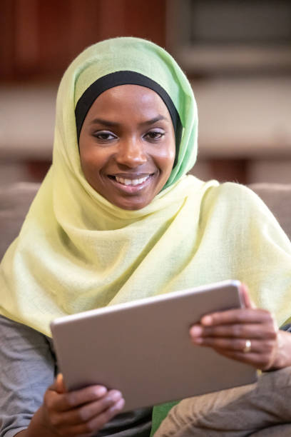 istock Smiling Muslim black young woman using her digital tablet 1063041812