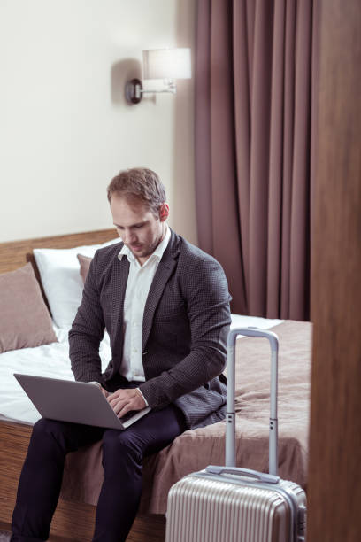 istock Businessman working on his laptop before leaving hotel room 1063042410