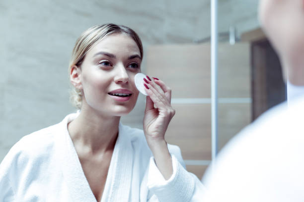 istock Beautiful young woman using cosmetics remover after work 1063044508