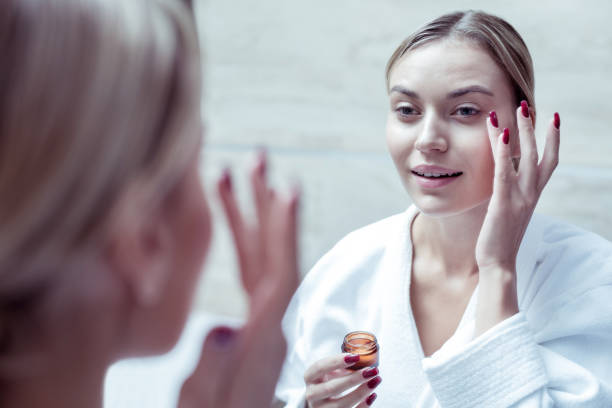 istock Blonde-haired woman removing her makeup after long working day 1063044522