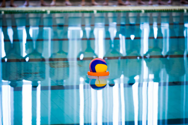 Water polo is a team water sport Water polo is a team water sport water polo cap stock pictures, royalty-free photos & images