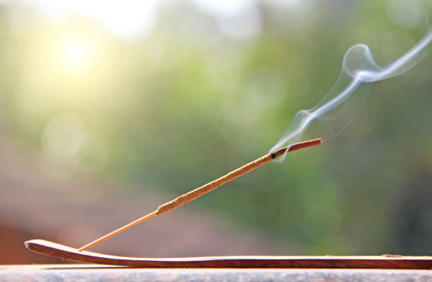 istock Incense stick and smoke from incense burning. Beautiful smoke. Blurred background and design with copy space 1063049044