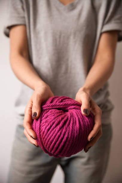 istock Yarn ball in female hands 1063051436
