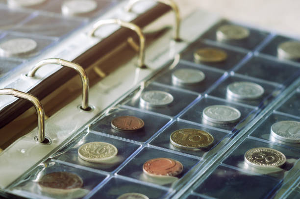 Coin collecting Close-up view of coins holding in blisters in coin album. Numismatics coin collection stock pictures, royalty-free photos & images