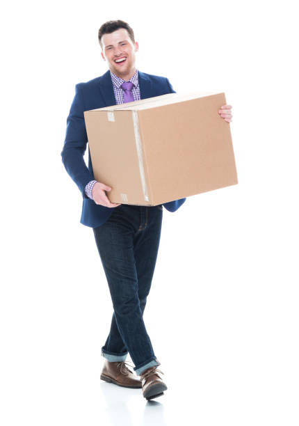 istock Businessman walking and holding a cardboard box 1063053898