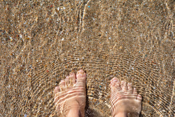 Barefoot wade in the Aegean sea, Greece