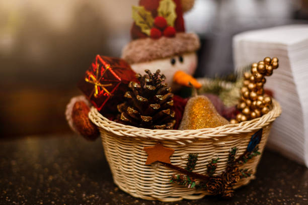Christmas home decor with pine cones, fruit, and a snowman