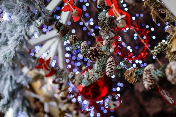 istock Christmas decor close-up, red angels, snowy Christmas tree, and cones 1063060396