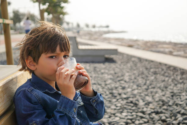 istock Little boy drinking chocolate milk 1063063314
