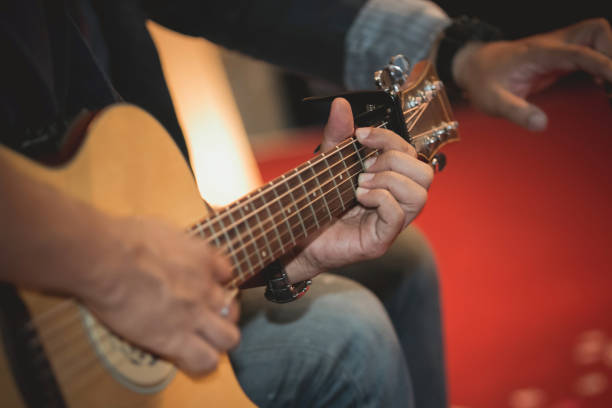 istock Close up of practicing playing guitar, man hand playing guitar,musical concept 1063065132