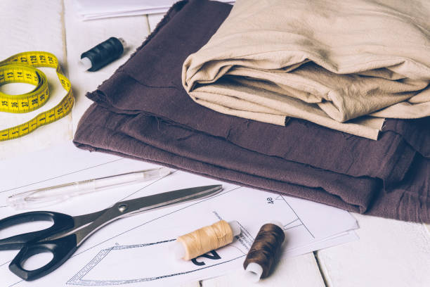 istock Sewing accessories and linen fabric on a white background. Sewing threads, pins, fabric, scissors and sewing centimeter 1063070420