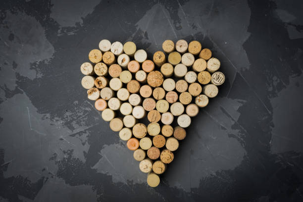 istock Wine corks heart on a black stone background. Top view 1063071510