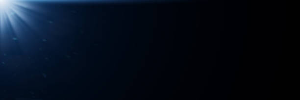 istock blue lens flare effect overlay texture in front of a black background - banner format 1063073284