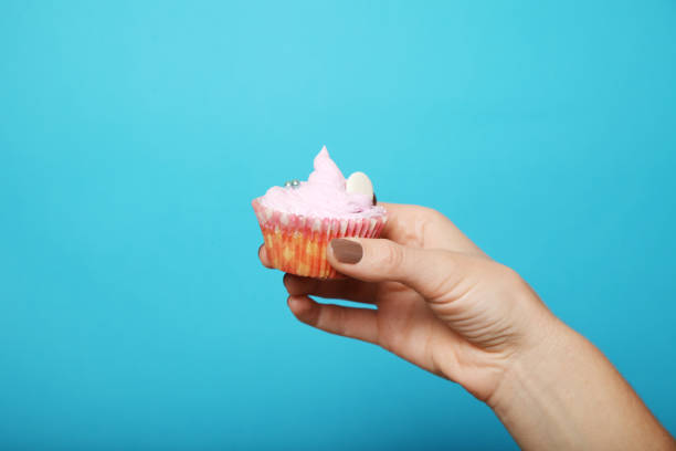 istock Sweet muffin cake in hand 1063081336
