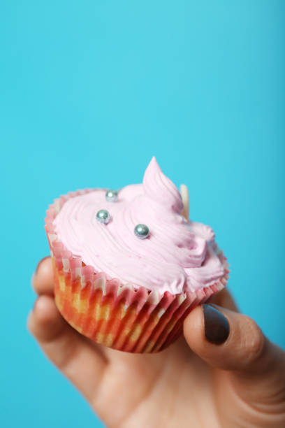 istock Yummy muffin in hand, sweet baking 1063081356