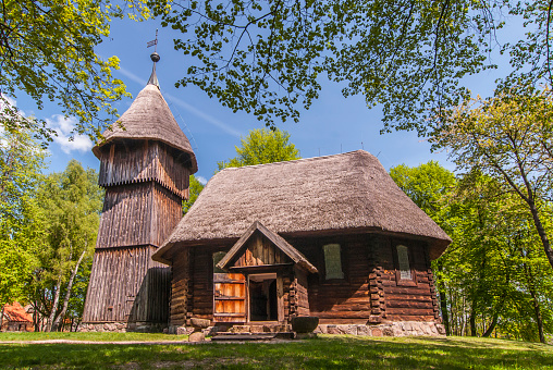 Old wooden evangelic church with and wooden belfry, both from Masuria region, Ethnographic Park in Olsztynek, Poland.