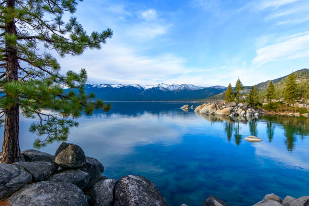 lake tahoe with snow capped mountain - nevada landscape rock tree imagens e fotografias de stock