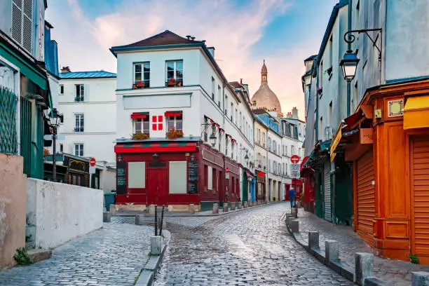 Empty street, cafe and the Sacre-Coeur in the morning, quarter Montmartre in Paris, France