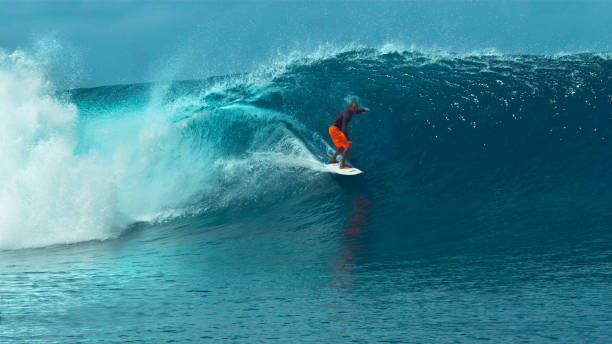 istock CLOSE UP: Fearless pro surfboarder rides a glassy emerald ocean wave in Tahiti. 1063095996