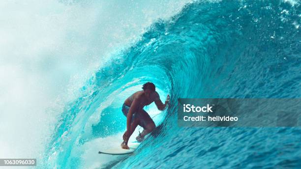 Close Up Exreme Athlete Surfs A Big Barrel Ocean Wave Glistening In The Sun Stock Photo - Download Image Now
