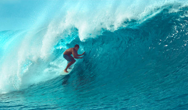 istock CLOSE UP: Cool surfer dude riding a giant barrel wave on a sunny summer day. 1063096070
