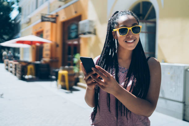 istock Tourist using phone and standing on street 1063103198