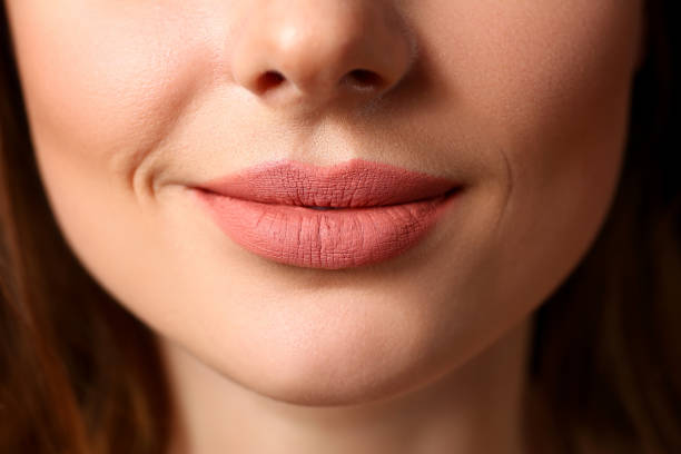 istock Smiling female closed red lips closeup 1063104626