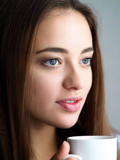 istock Beautiful young woman hold in arms white cup 1063105694