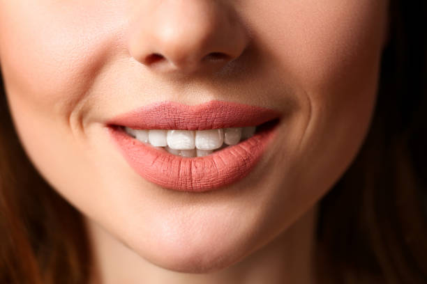 istock Smiling female closed red lips closeup 1063105716