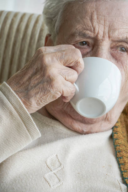 istock Senior woman drinking coffee / tea 1063115878
