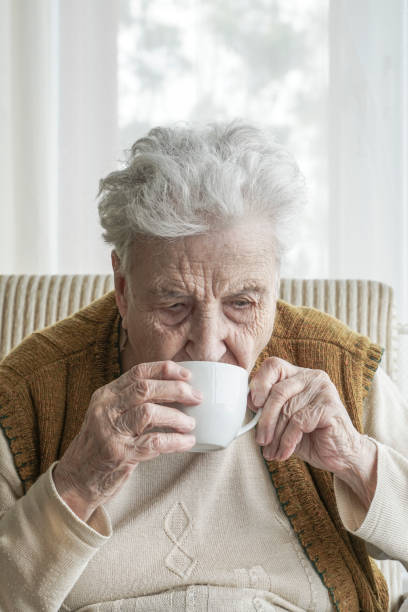 istock Senior woman drinking coffee / tea 1063115882
