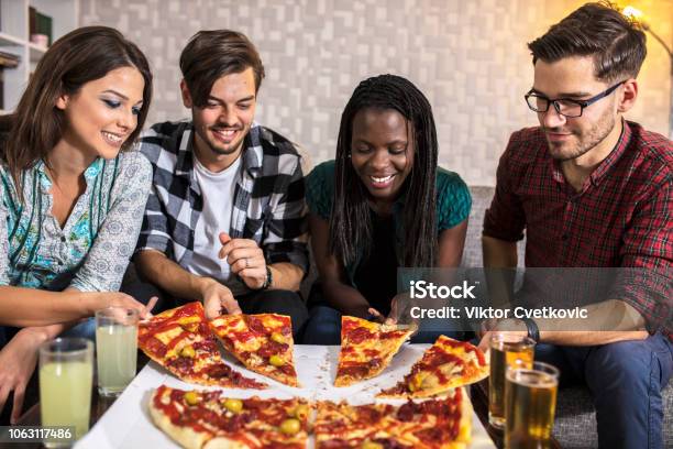 Group Of Friends Eating Pizza Together At Home Stock Photo, Picture and  Royalty Free Image. Image 56950664.