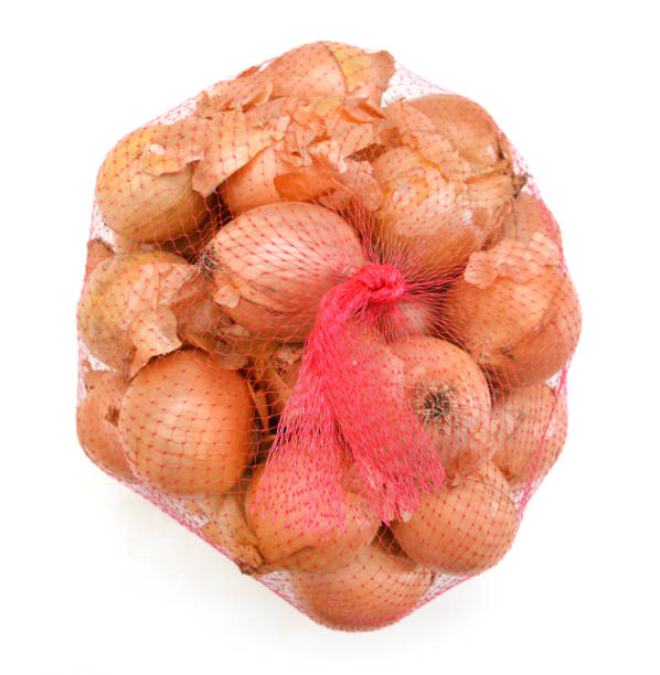istock Onions isolated on white in a fishnet. 1063120674