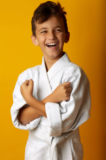 istock Cheerful boy in white kimono smiling at camera 1063120852