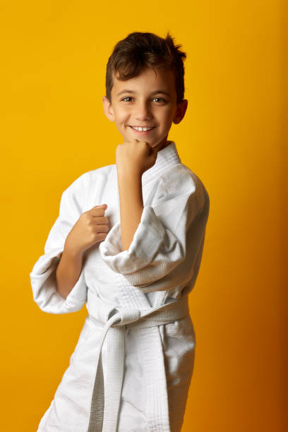 istock Smiling boy in white fighter kimono 1063121062