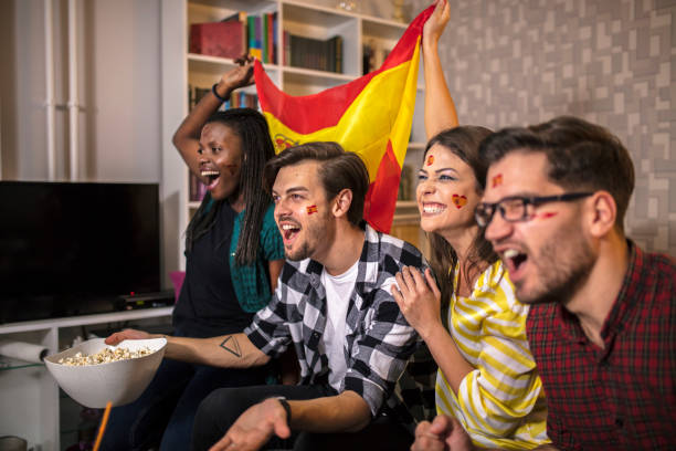 istock Spanish supporters rejoices watching television 1063121280
