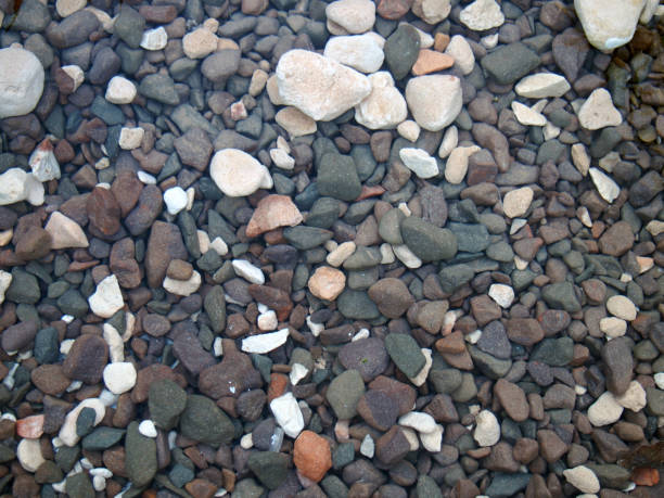 istock a full frame image of different colored rocks and pebbles in running water and the bottom of a river 1063130128